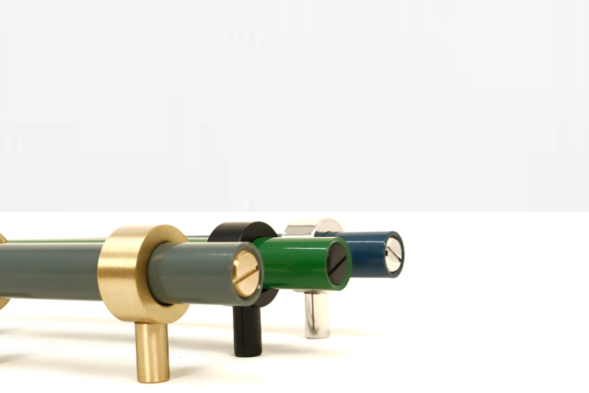 Brass and charcoal, black and python green, and nickel and slate blue color Caliber pull by Dutton Brown