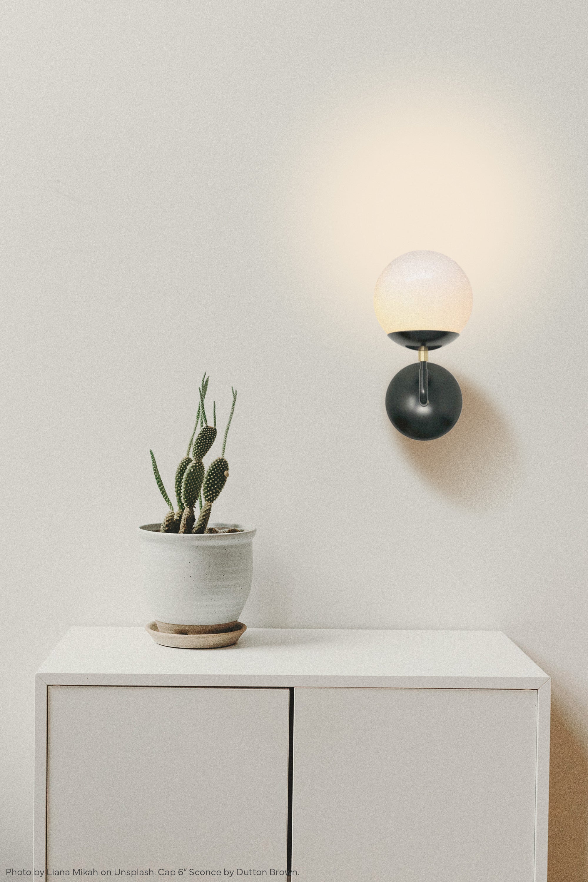 Black and brass Cap sconce 6" by Dutton Brown. Photo by Liana Mikah via Unsplash. _hover